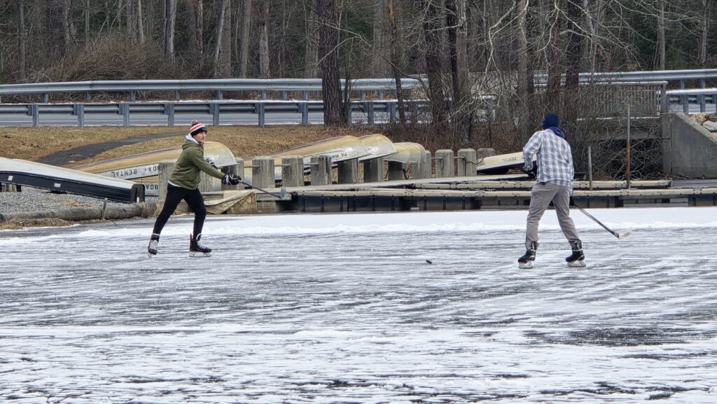 Image of people playing hockey (2) for the Ultimate Guide to Frozen Laurel Lake in the Winter - Pine Grove Frunace State Park in Michaux State Forest - Awesome Carlisle! - Carlisle PA Guides and News