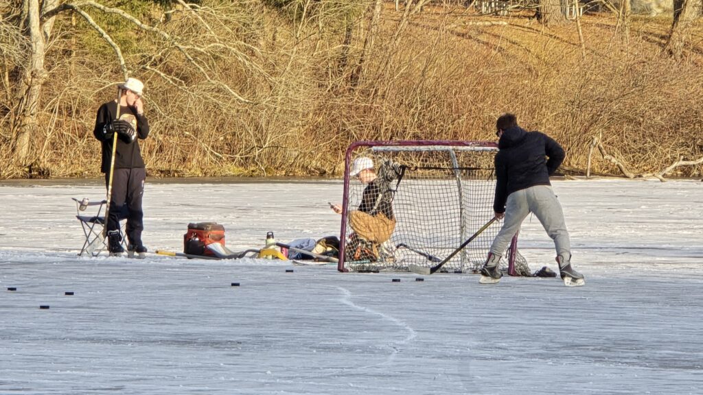 Image of peopleplaying hockey for the Ultimate Guide to Frozen Laurel Lake in the Winter - Pine Grove Frunace State Park in Michaux State Forest - Awesome Carlisle! - Carlisle PA Guides and News
